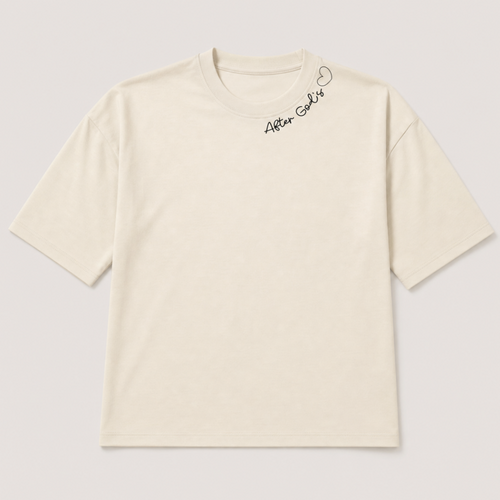 An off-white short-sleeve t-shirt with a small black script logo and heart outline on the upper right chest, displayed flat against a light gray background.