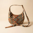 Patterned handbag with a strap on a beige background