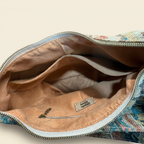 Open bag with a visible brand label on a neutral background