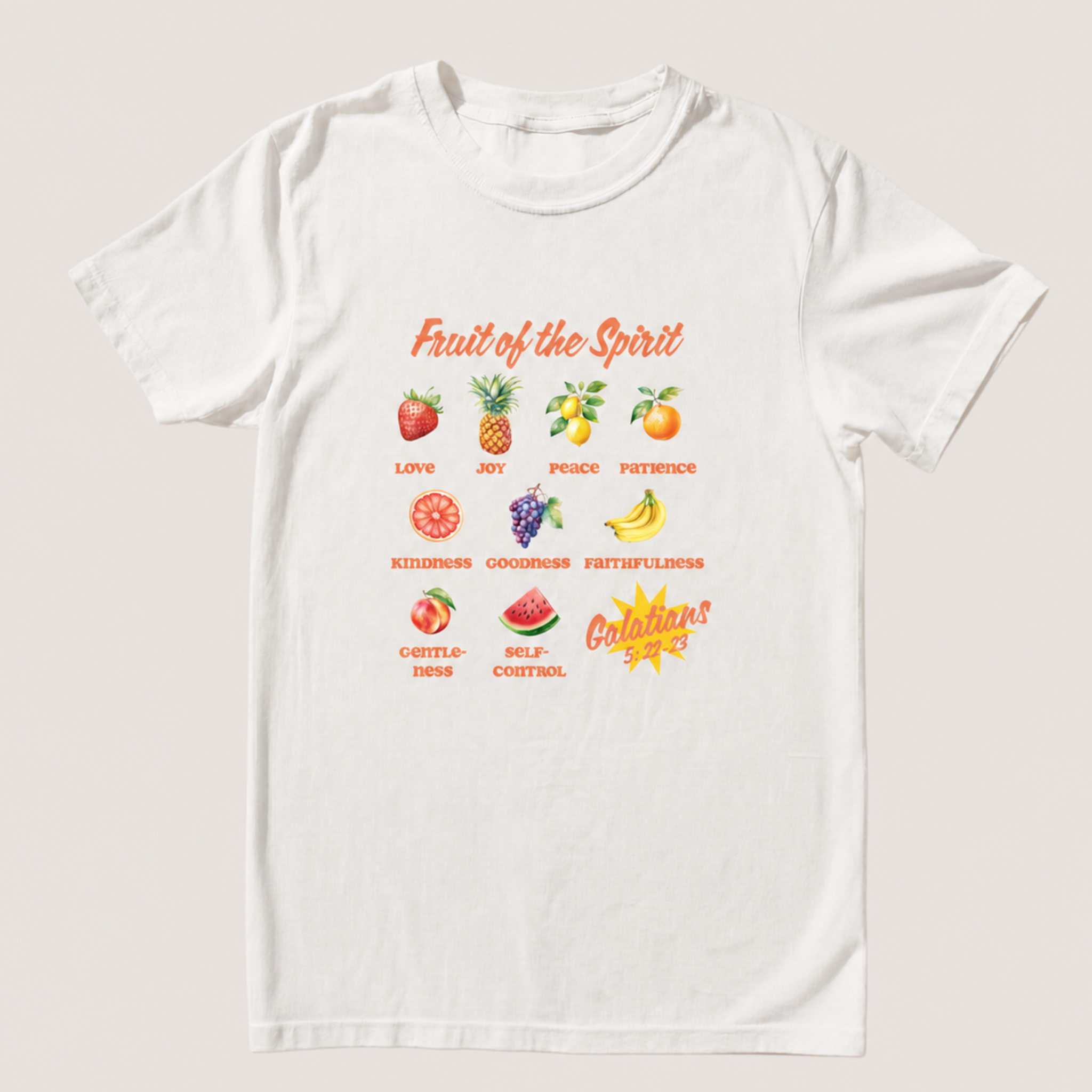 A white short-sleeve crewneck t-shirt with a colorful graphic print on the front. The graphic features various fruits (strawberries, pineapple, mango, banana, watermelon) paired with positive words like Love, Joy, Peace, Patience, Kindness, Goodness, Fruitfulness, Self-Control, and Calmness, along with a yellow sunburst that reads 'Galatians!'.