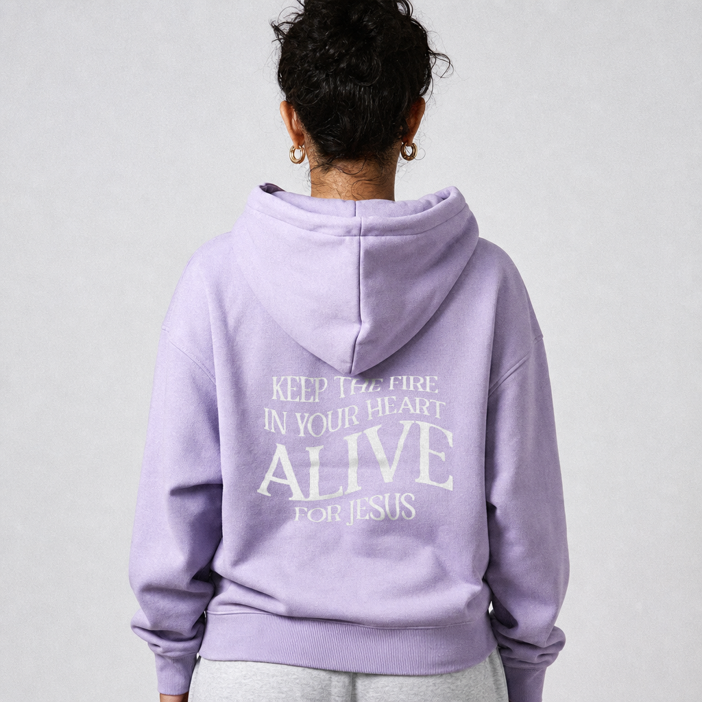 Person wearing a lavender hoodie with a motivational quote on the back against a plain background