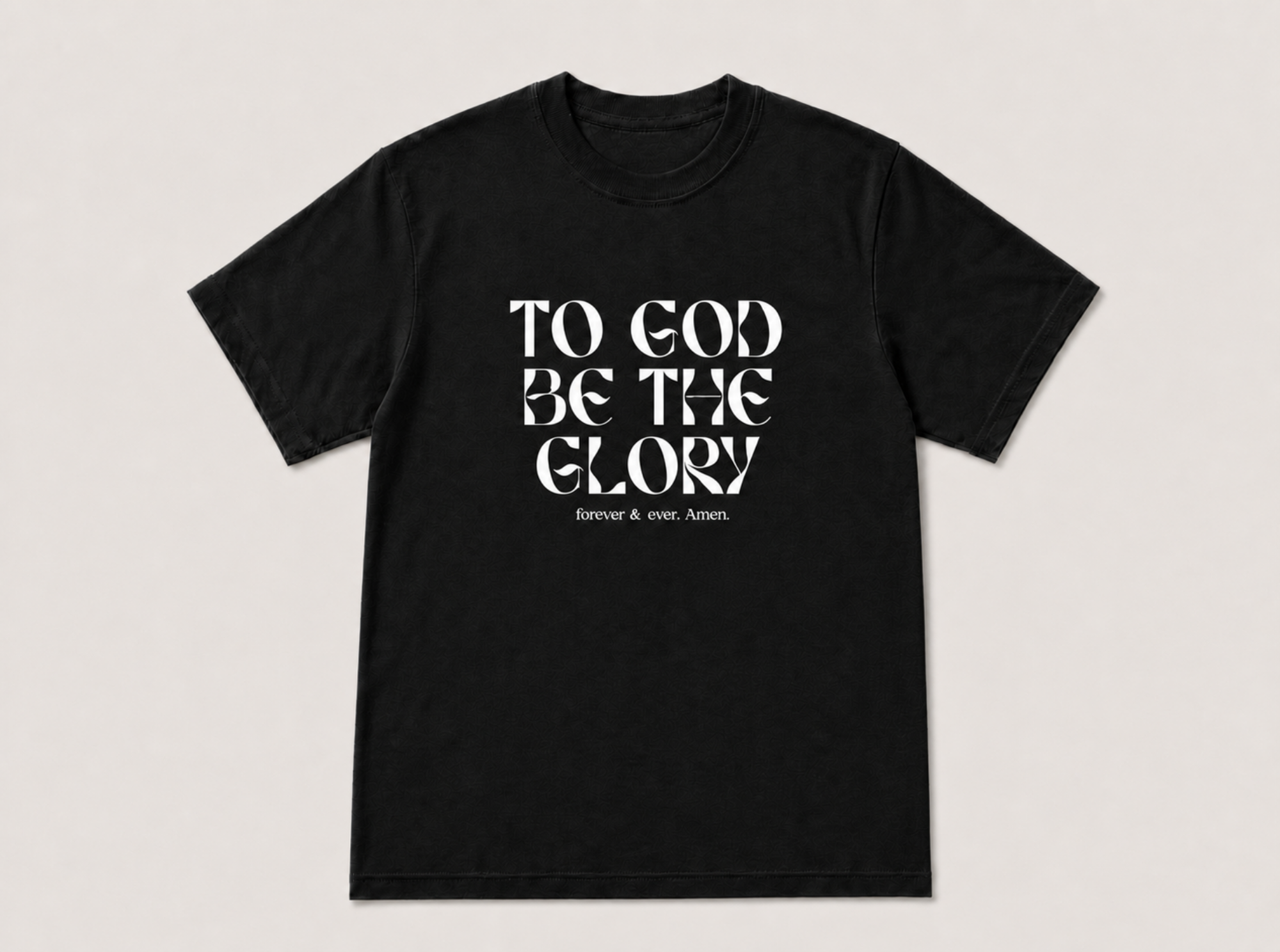 A black short-sleeve crewneck t-shirt with the text 'TO GOD BE THE GLORY' printed in a stylized white serif font on the chest, with 'forever and ever, AMEN' in smaller text below, displayed against a light gray background.